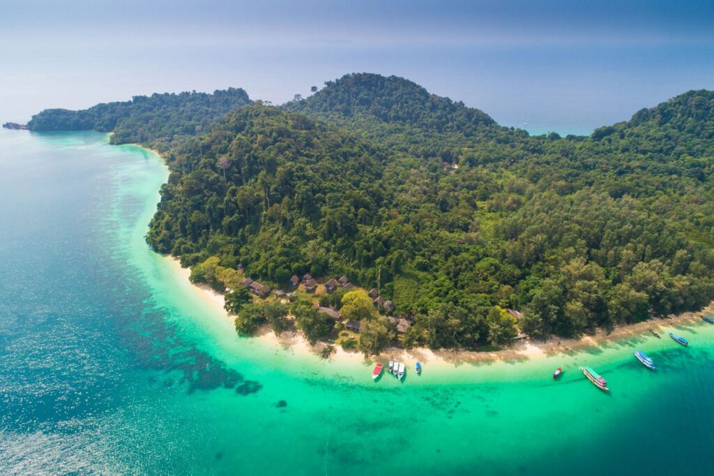 Aerial view wide shot beautiful landscape sunset tropical beach sea in south thailand Asia